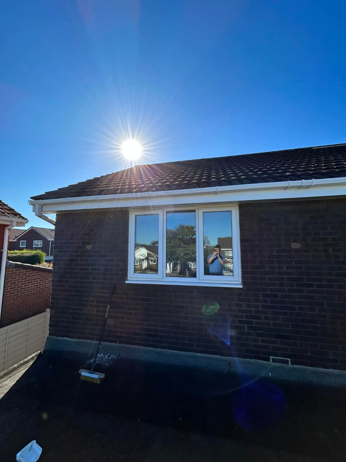 Tiled roof and white guttering on home